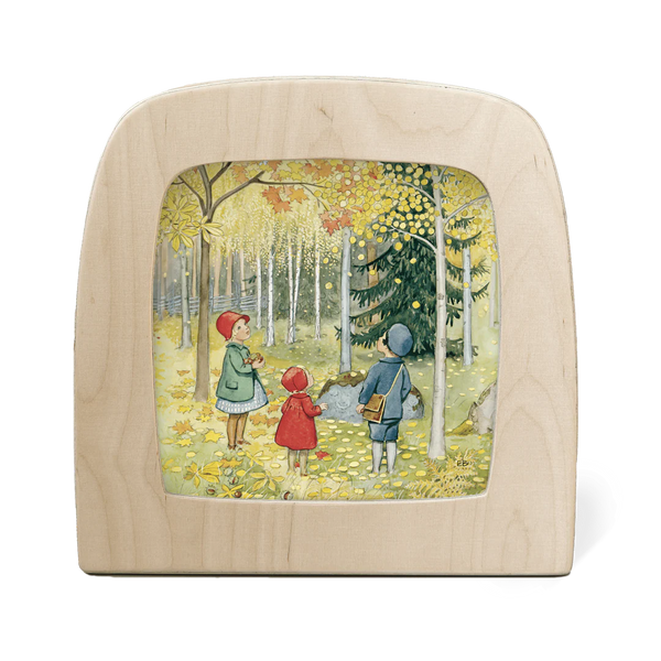 Wooden lamp with a printed silhouette inside of children in an autumn forest.